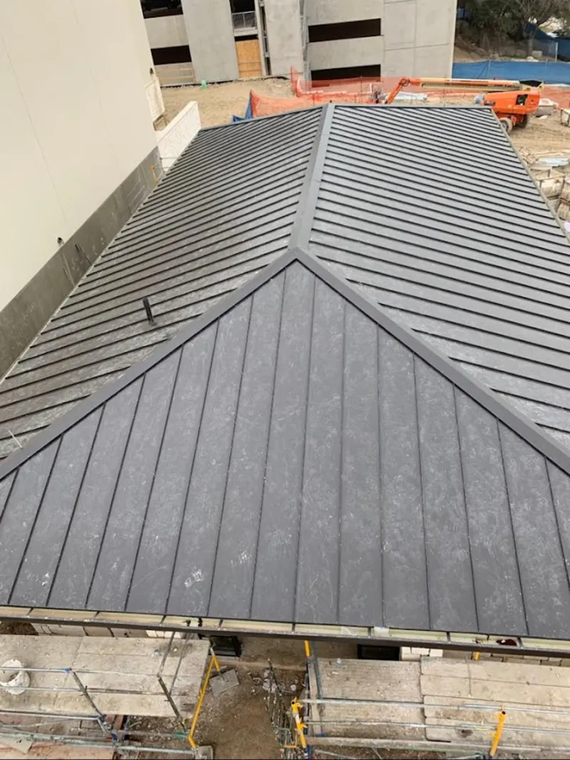 Commercial metal roof construction with crane equipment in South St. Paul